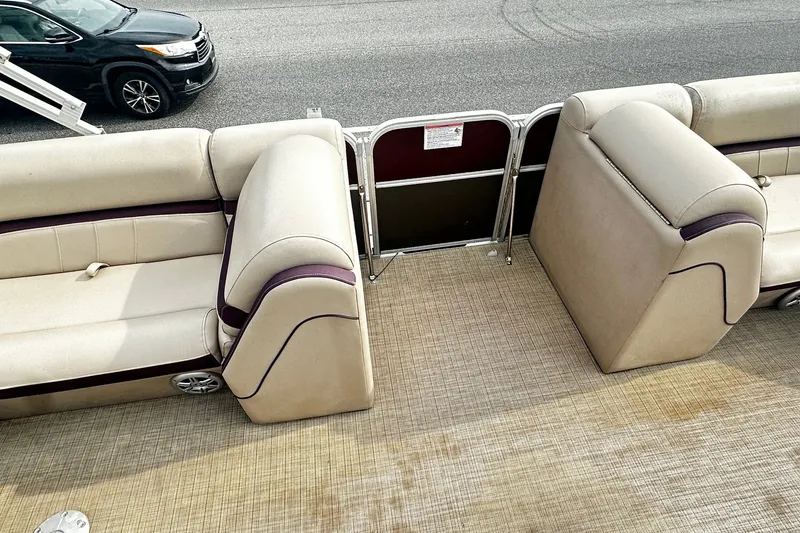 Slide: The Image of 2018 Berkshire Pontoon interior with beige seating and carpeted floor. - 10