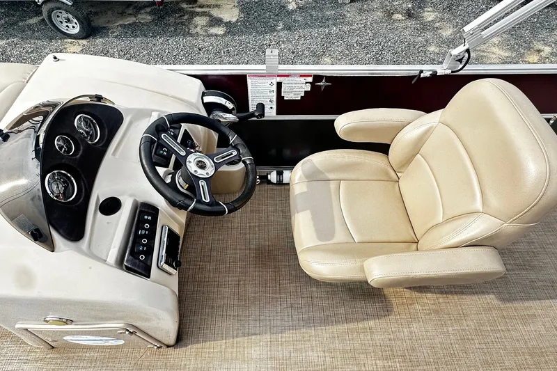 Slide: The Image of Captain's chair and steering console of a 2018 Berkshire Pontoon boat. - 5