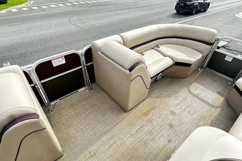 Slide: The Image of 2018 Berkshire Pontoon boat interior with beige seating and spacious deck. - 11