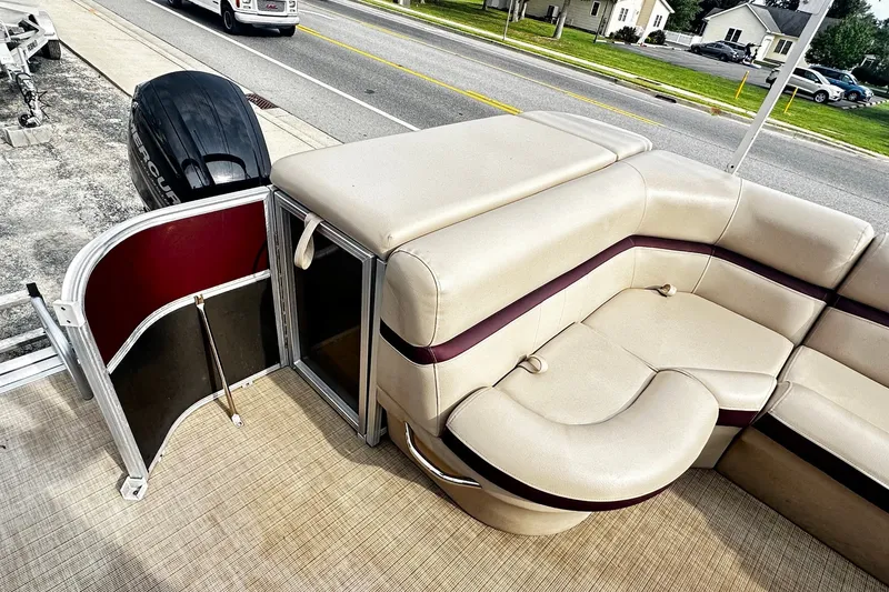 Slide: The Image of 2018 Berkshire Pontoon boat interior with beige seating and open side gate. - 12