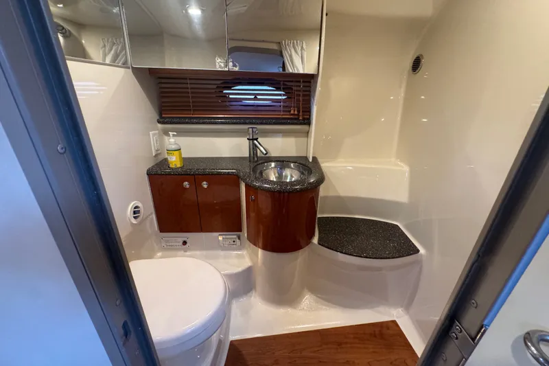 Slide: The Image of 2009 Formula 400 Super Sport yacht bathroom with modern sink, toilet, and wooden cabinetry. - 21