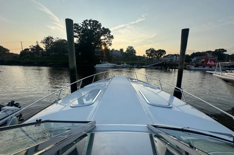 Slide: The Image of 2009 Formula 400 Super Sport yacht docked at sunset, serene waterfront view. - 14