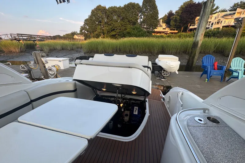 Slide: The Image of 2009 Formula 400 Super Sport boat docked, open engine compartment, scenic waterfront view. - 40