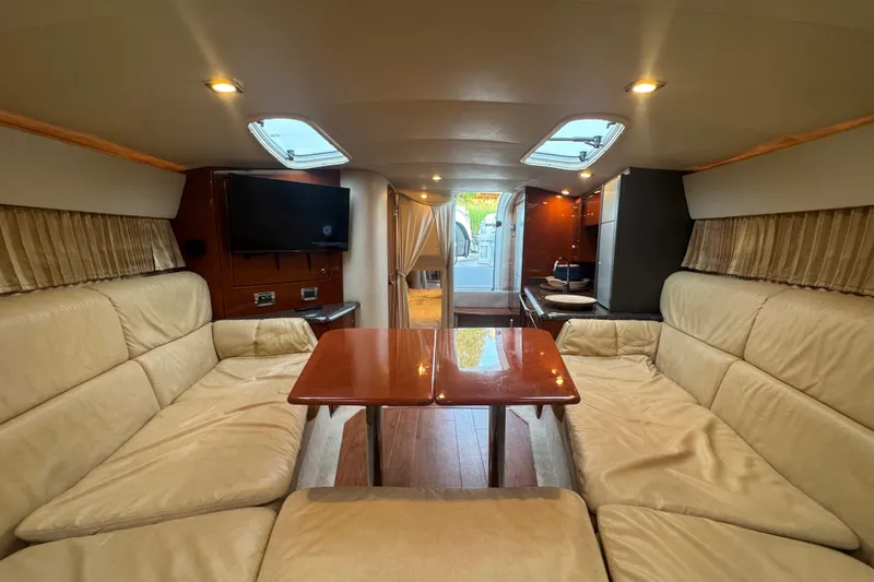 Slide: The Image of Interior of a 2009 Formula 400 Super Sport yacht with beige seating and wooden table. - 30
