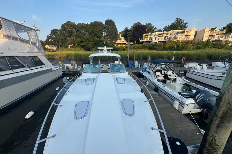 Slide: The Image of 2009 Formula 400 Super Sport yacht docked at marina with surrounding boats and waterfront homes. - 16
