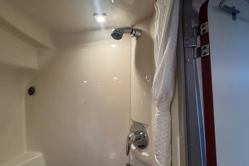 Slide: The Image of Shower area inside 2009 Formula 400 Super Sport boat, featuring modern fixtures and lighting. - 22