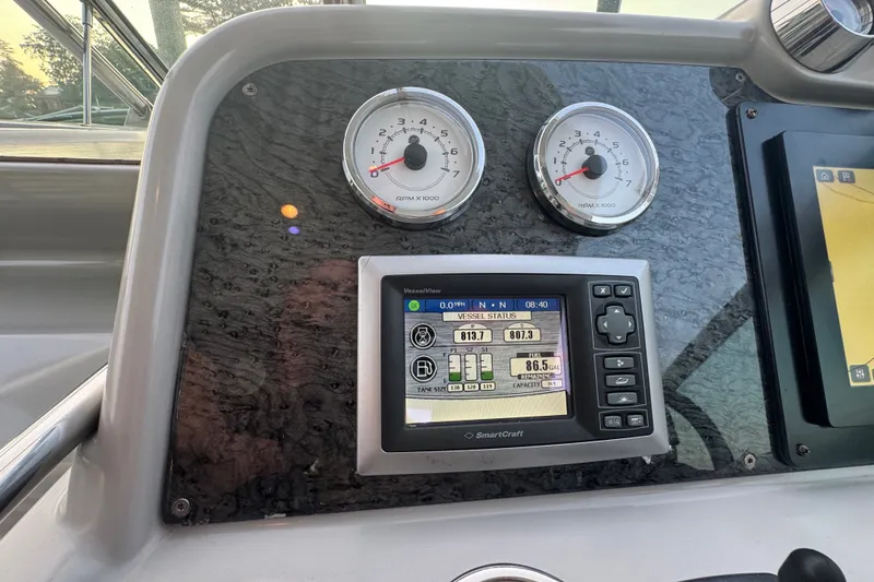 Slide: The Image of Dashboard of a 2009 Formula 400 Super Sport boat with gauges and SmartCraft display. - 38