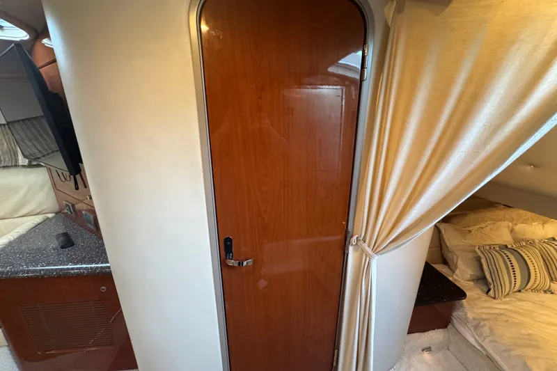 Slide: The Image of Interior of 2009 Formula 400 Super Sport yacht with wooden door and cozy sleeping area. - 20