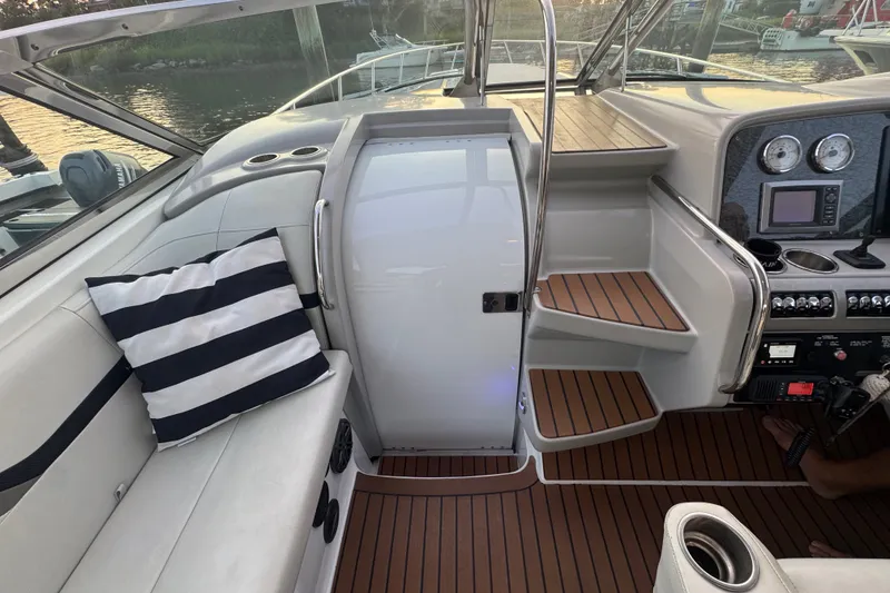 Slide: The Image of 2009 Formula 400 Super Sport boat interior with striped cushion and wooden flooring. - 35