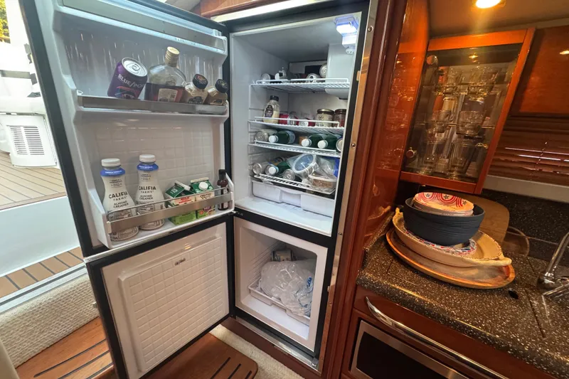 Slide: The Image of Open refrigerator in 2009 Formula 400 Super Sport yacht kitchen, stocked with beverages and food. - 26