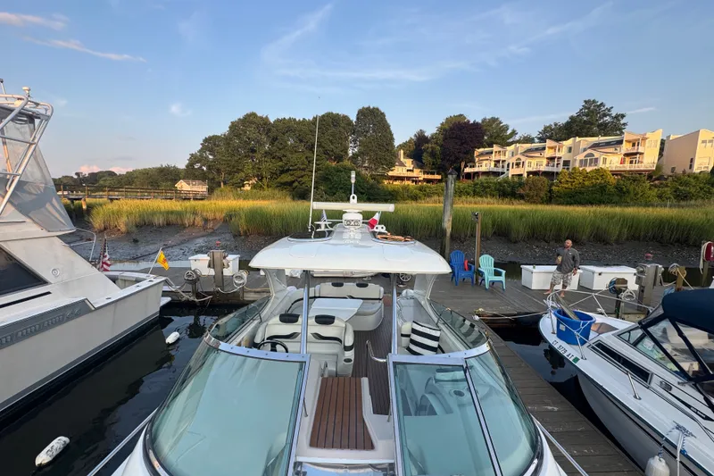 Slide: The Image of 2009 Formula 400 Super Sport yacht docked at a scenic marina with waterfront homes. - 17