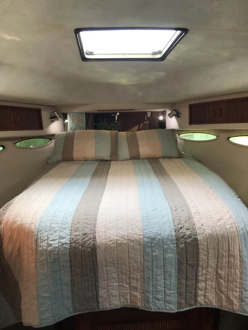 Slide: The Image of Cabin with a cozy double bed and porthole windows allowing natural light in. - 27