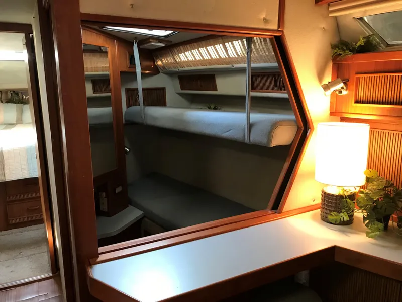 Slide: The Image of Interior of a 1987 Sea Ray 390 Express Cruiser with a cozy seating area and lamp. - 7
