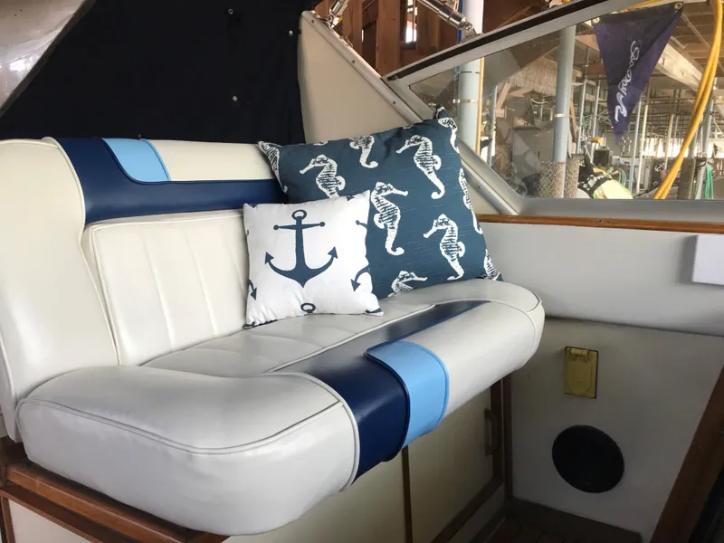 Slide: The Image of A cozy seating area with blue and white cushions, featuring anchor and seahorse designs. - 30