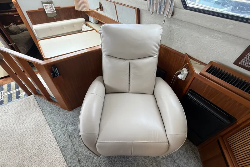 Slide: The Image of Luxurious interior of 1986 Sea Ray 410 Aft Cabin with plush leather chair. - 19