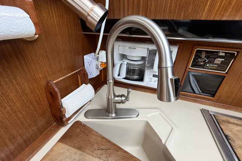 Slide: The Image of 1986 Sea Ray 410 Aft Cabin kitchen with modern faucet and coffee maker. - 32