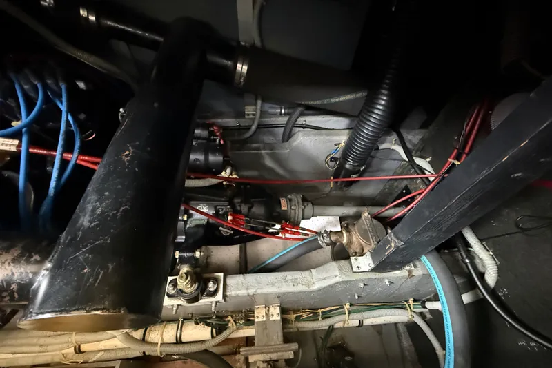 Slide: The Image of Engine compartment of a 1986 Sea Ray 410 Aft Cabin with visible wiring and components. - 57