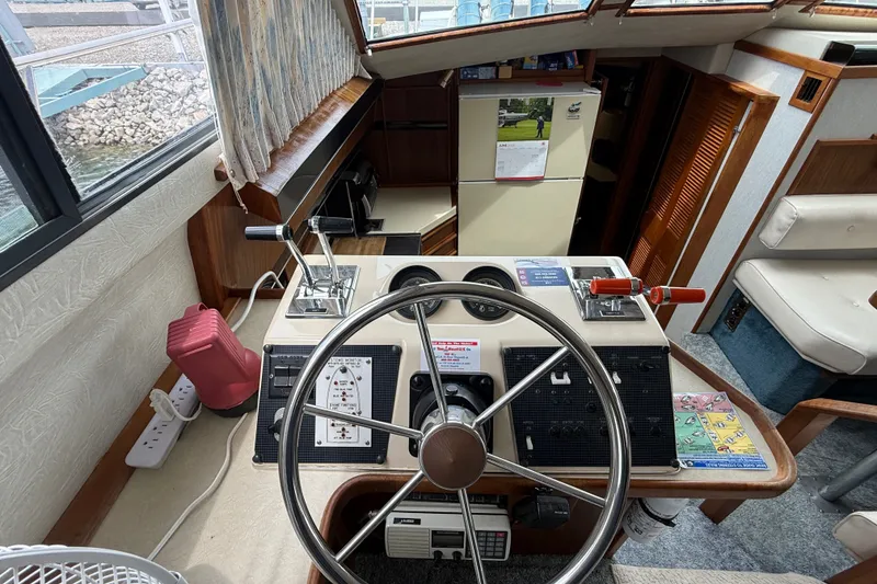Slide: The Image of Interior helm of 1986 Sea Ray 410 Aft Cabin with steering wheel and controls. - 22