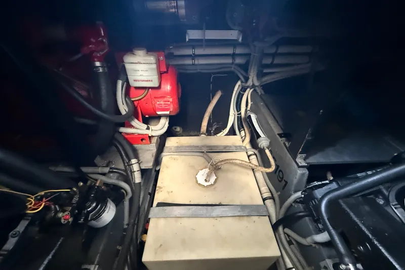 Slide: The Image of Engine room of 1986 Sea Ray 410 Aft Cabin with visible wiring and components. - 55