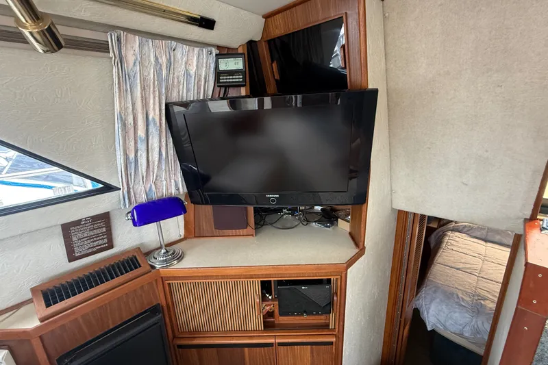 Slide: The Image of Interior of 1986 Sea Ray 410 Aft Cabin with TV and blue lamp. - 21