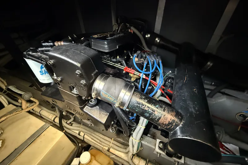 Slide: The Image of Engine compartment of a 1986 Sea Ray 410 Aft Cabin boat, showcasing mechanical components. - 53