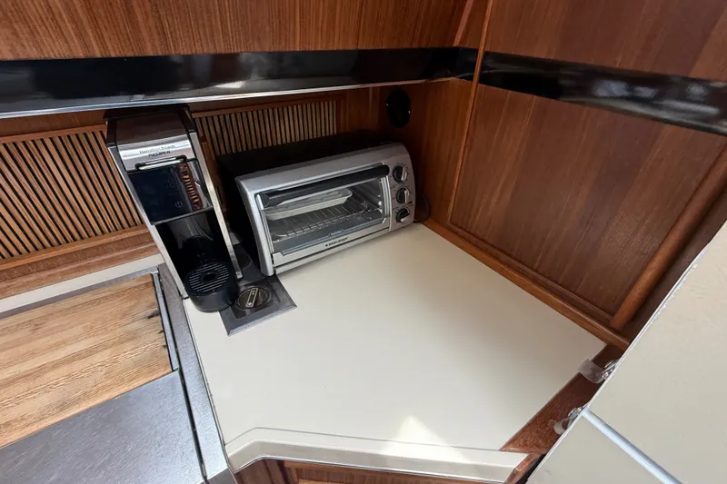 Slide: The Image of 1986 Sea Ray 410 Aft Cabin kitchen with coffee maker and toaster oven. - 34