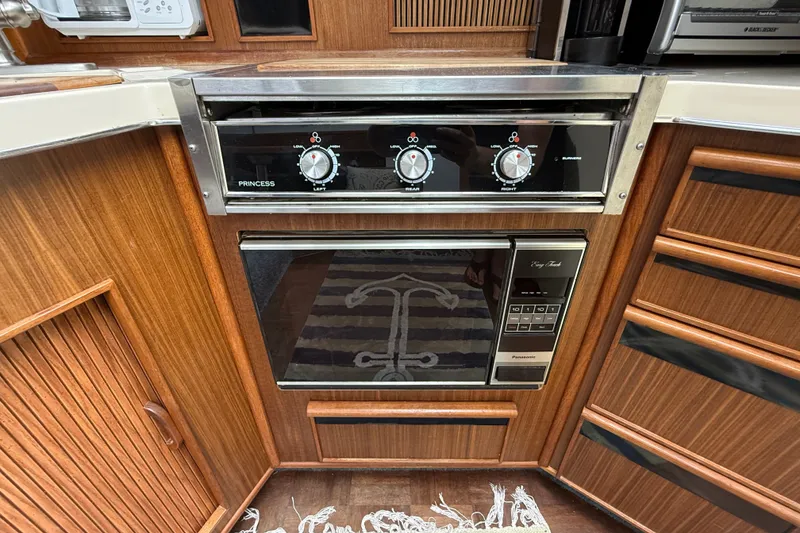 Slide: The Image of 1986 Sea Ray 410 Aft Cabin kitchen with Princess stove and Panasonic microwave. - 29