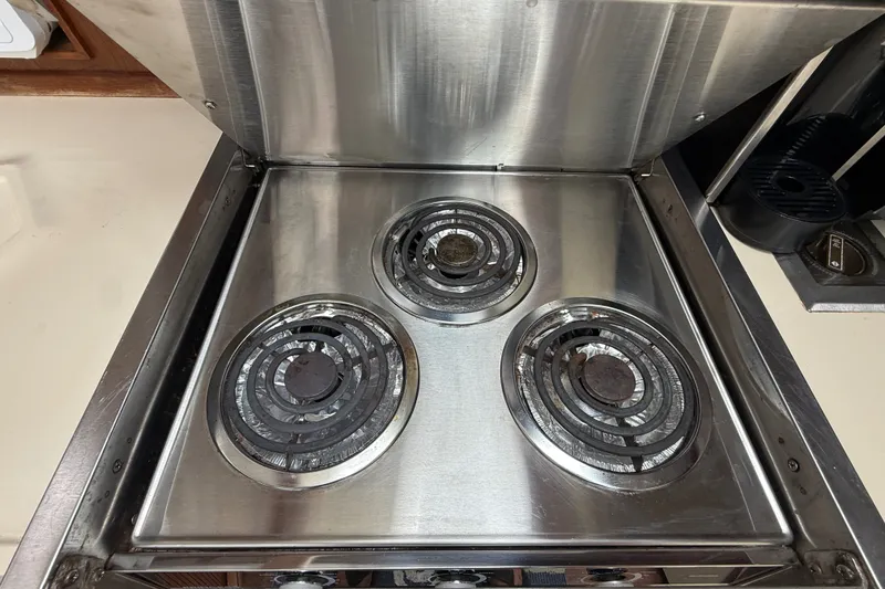 Slide: The Image of Stainless steel stove with three burners on a 1986 Sea Ray 410 Aft Cabin yacht. - 33