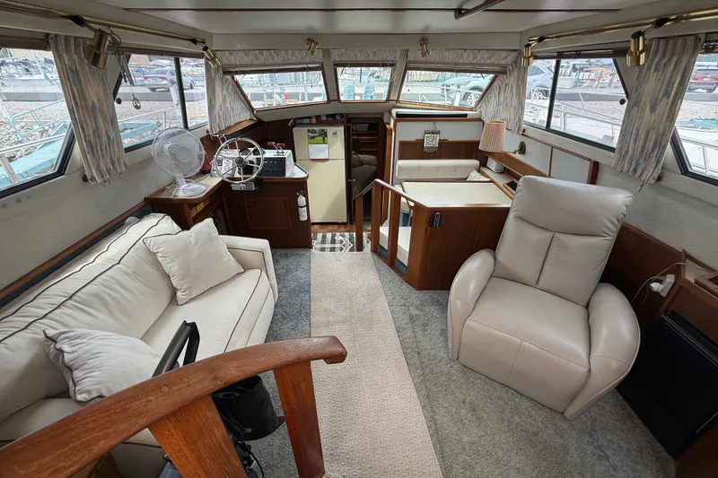 Slide: The Image of Interior of 1986 Sea Ray 410 Aft Cabin yacht with cozy seating and helm station. - 15