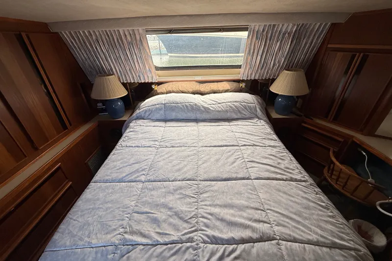 Slide: The Image of Cozy bedroom in 1986 Sea Ray 410 Aft Cabin yacht with double bed and lamps. - 43