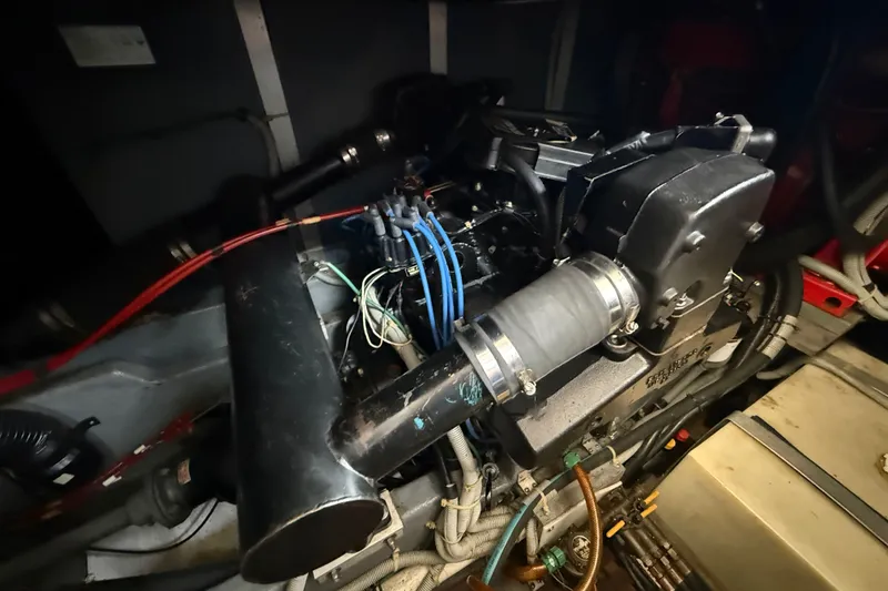 Slide: The Image of Engine compartment of a 1986 Sea Ray 410 Aft Cabin boat, showcasing mechanical components. - 54