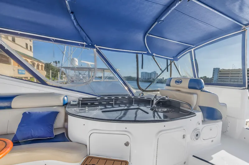 Slide: The Image of 2007 Neptunus 62 Flybridge yacht interior with blue canopy and seating area. - 30