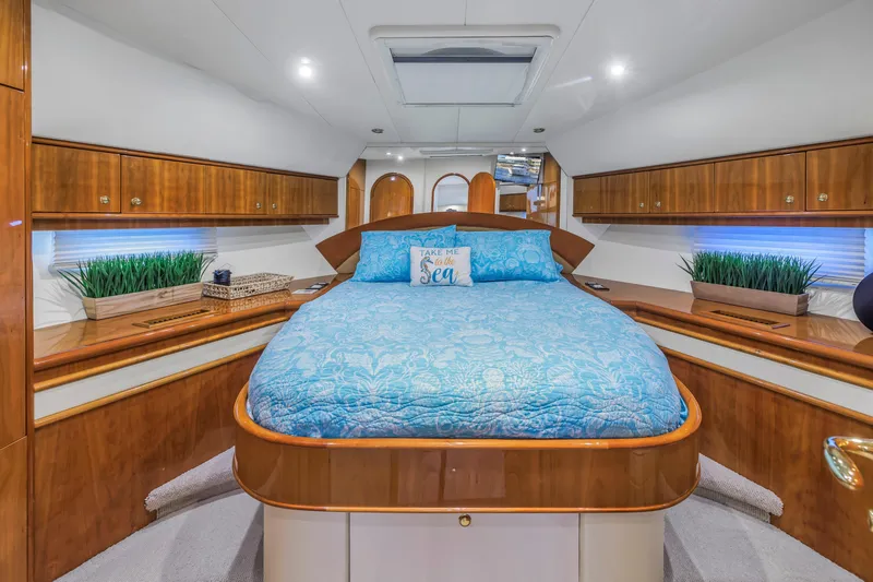 Slide: The Image of Luxurious 2007 Neptunus 62 Flybridge bedroom with blue bedding and elegant wood finishes. - 10