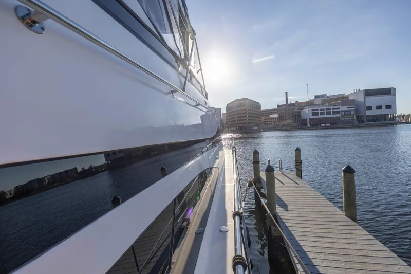 Slide: The Image of 2007 Neptunus 62 Flybridge yacht docked at a sunny waterfront marina. - 43