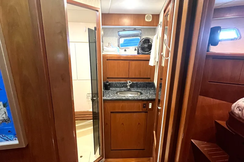 Slide: The Image of Interior of a 2002 Grand Alaskan 53 RPH with wood paneling and a sink. - 28