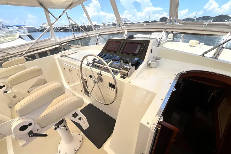 Slide: The Image of The image shows the helm of a 2002 Grand Alaskan 53 RPH with modern instruments. - 41