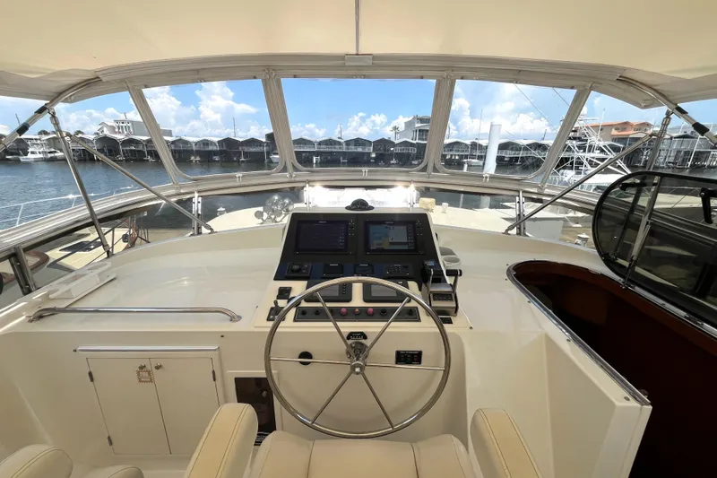 Slide: The Image of The image shows the helm of a 2002 Grand Alaskan 53 RPH with a large steering wheel and modern instruments. - 40