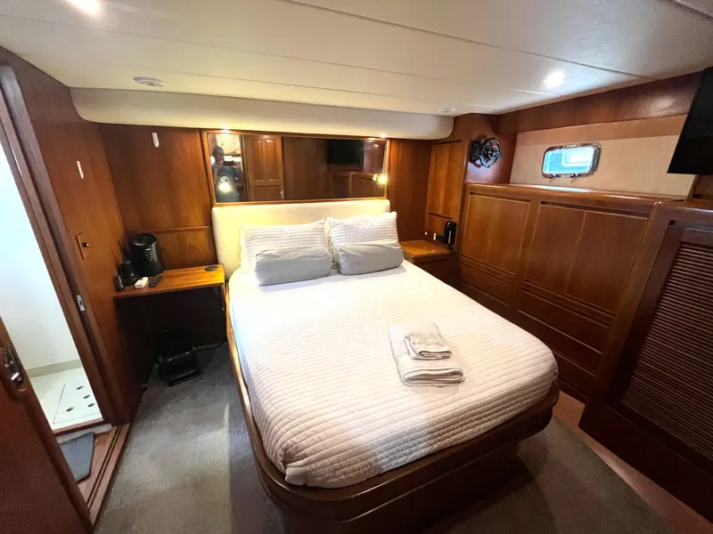 Slide: The Image of The 2002 Grand Alaskan 53 RPH cabin features a cozy bed with wooden furnishings. - 31