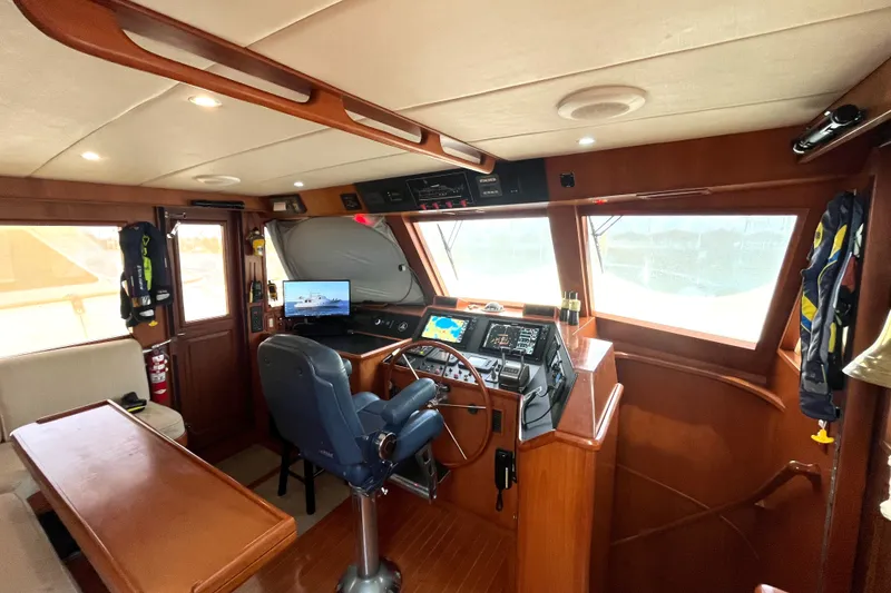 Slide: The Image of Interior of the 2002 Grand Alaskan 53 RPH with helm station and navigation equipment. - 16