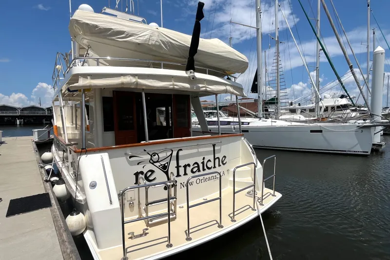 Slide: The Image of A 2002 Grand Alaskan 53 RPH docked. The name "re-fraiche" is visible on the stern. - 3