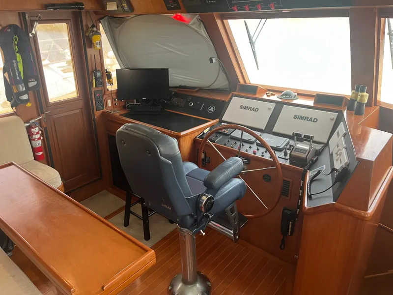 Slide: The Image of The image shows the helm of a 2002 Grand Alaskan 53 RPH with modern navigation equipment. - 15