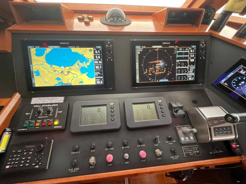 Slide: The Image of The image shows the helm of a 2002 Grand Alaskan 53 RPH with navigation screens and controls. - 20
