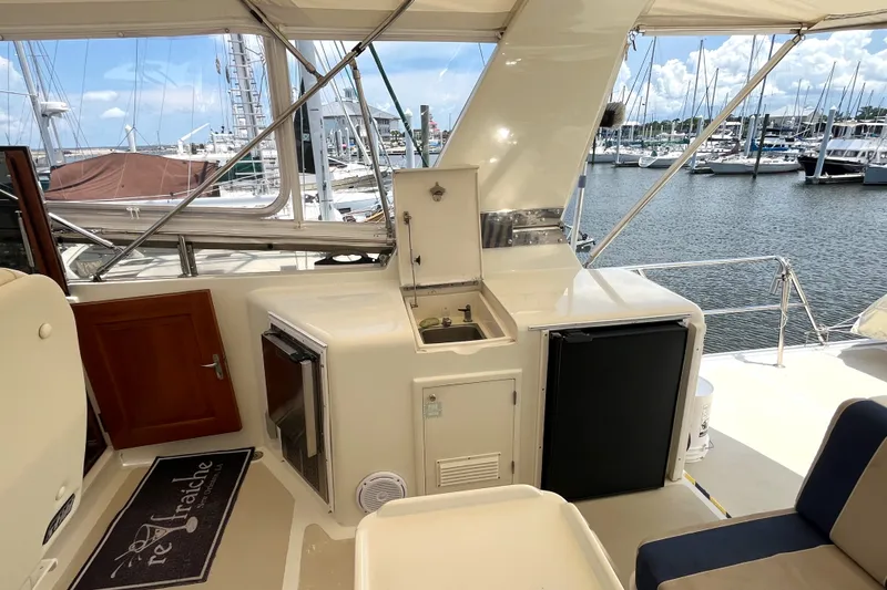 Slide: The Image of The 2002 Grand Alaskan 53 RPH flybridge features a sink, refrigerator, and seating area. - 49