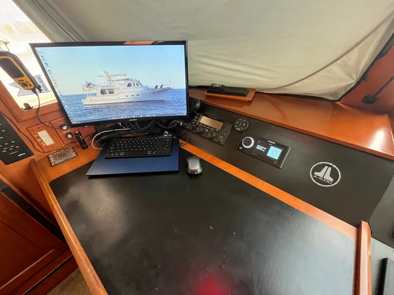 Slide: The Image of The helm of a 2002 Grand Alaskan 53 RPH with a monitor and navigation equipment. - 21
