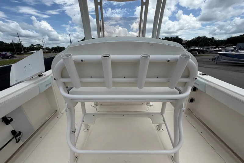 Slide: The Image of 2019 Robalo R222 Center Console boat interior with rod holders and seating. - 16