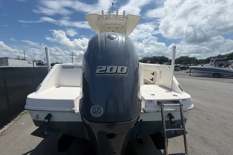 Slide: The Image of 2019 Robalo R222 Center Console boat with powerful 200 horsepower engine, parked outdoors. - 3