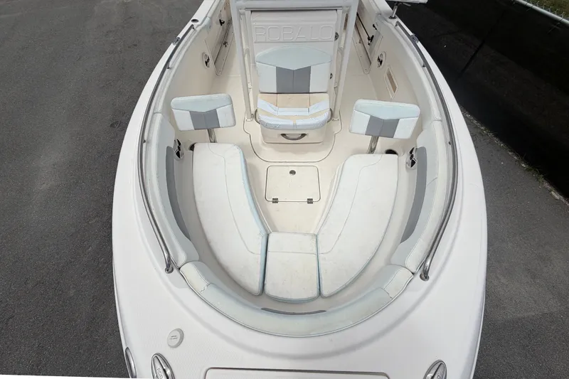 Slide: The Image of The image shows the cockpit of a 2019 Robalo R222 Center Console boat with cushioned seating. - 45