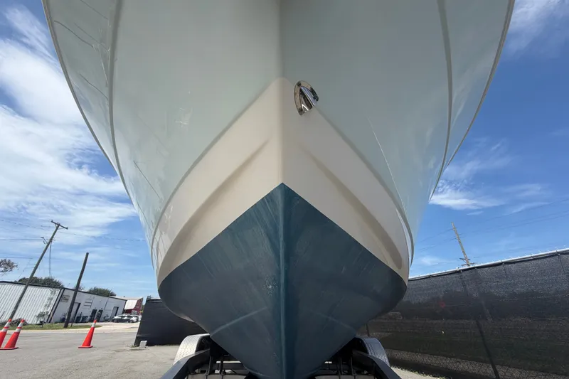 Slide: The Image of 2019 Robalo R222 Center Console boat on trailer, viewed from below against blue sky. - 11