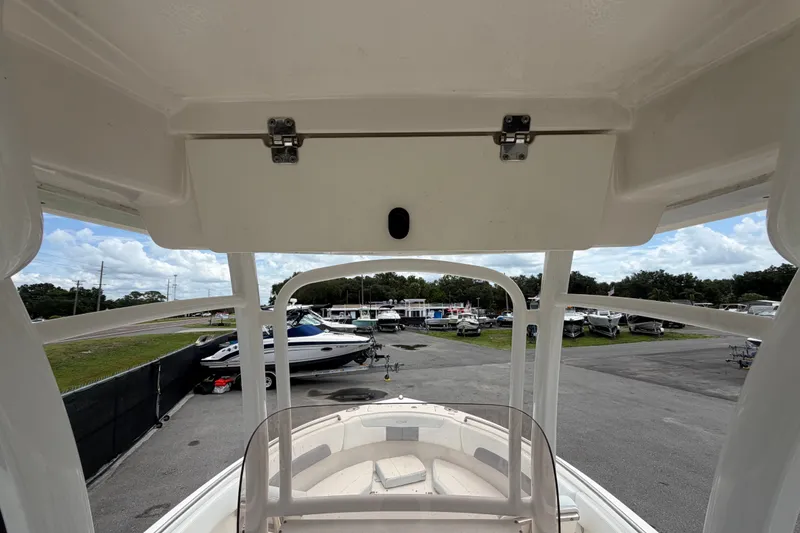 Slide: The Image of 2019 Robalo R222 Center Console boat interior view at a marina. - 18