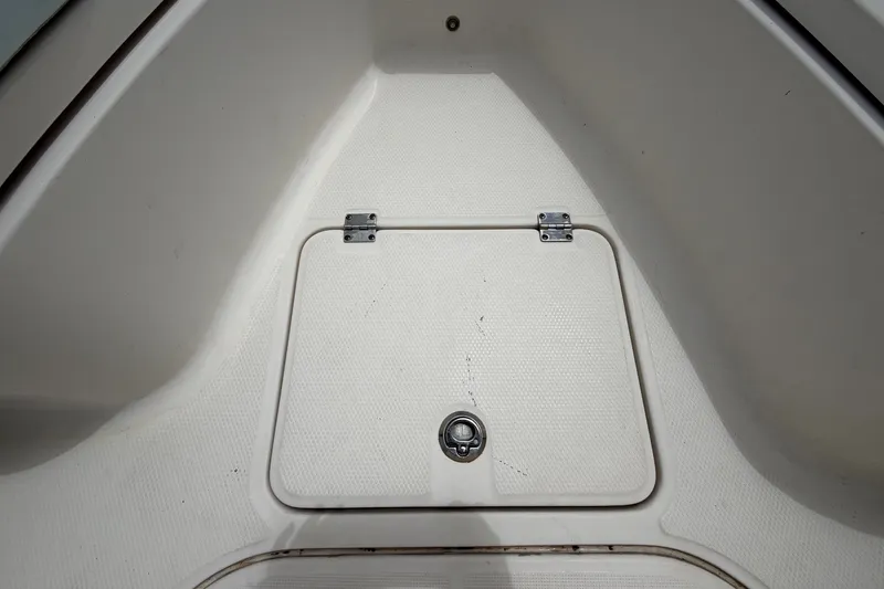 Slide: The Image of A storage compartment lid on a boat with hinges and a latch. - 34